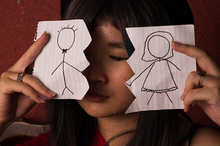 Fiú és lány rajza, középen eltépett papíron